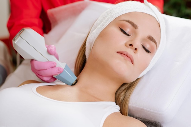 Woman taking treatment with radio wave lifting in the spa center