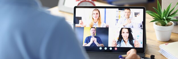 パンデミックの間にデジタルタブレットのクローズアップテレワークを使用して電話会議を話している女性