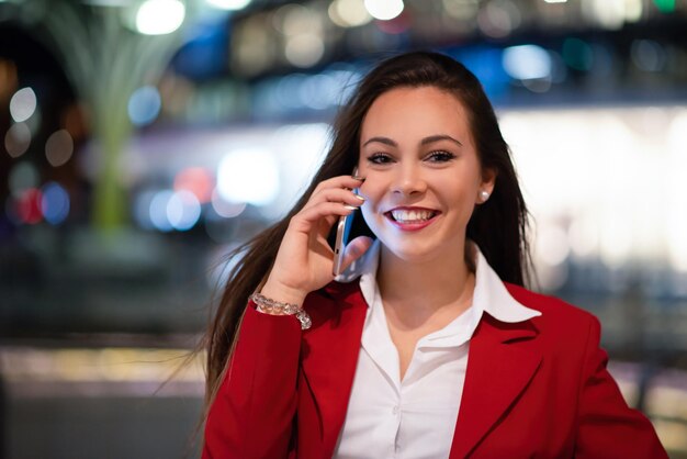 Woman talking on her mobile phone at night