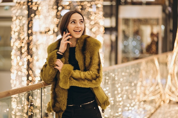 Woman talking on a phone in a shopping centre