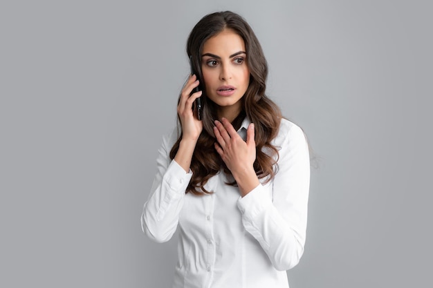 Woman talking on phone Young woman with mobile phone Businesswoman with smartphone grey background