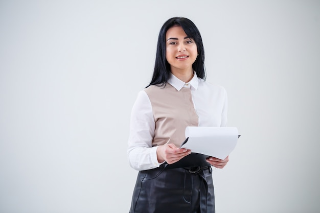 Woman teacher, business coach, mentor holds a folder with a new business project in her hands