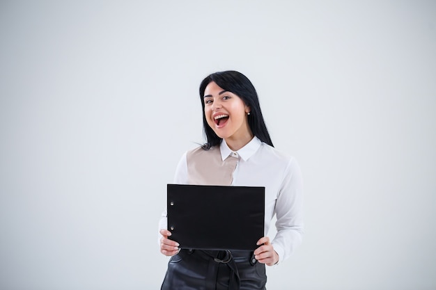 Woman teacher, business coach, mentor holds a folder with a new business project in her hands