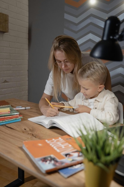 A Woman Teaching a Boy Stock Photo