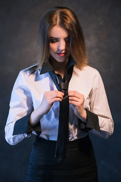 Woman teachs or learns how to knot a tie. Helpful and detailed tutorial concept