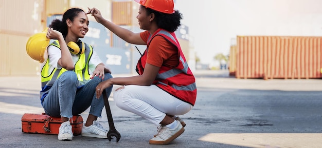 Photo woman technician or maintenance worker and sitting down on mechanic tool boxnear