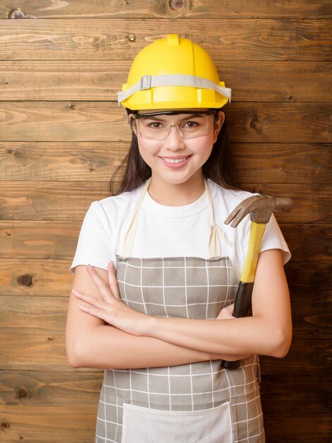 Woman technician portrait on wood background