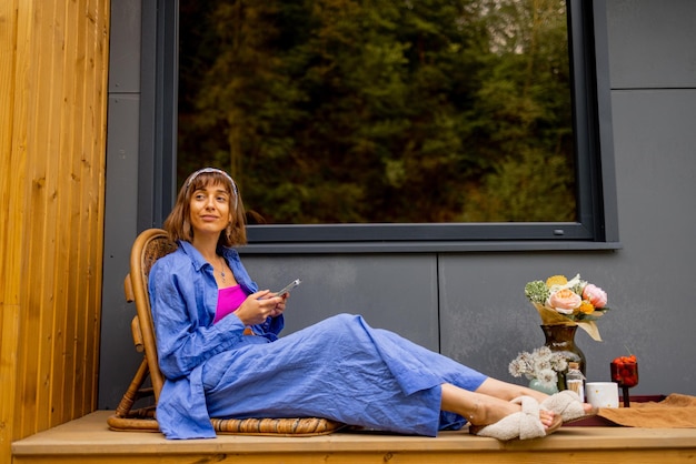 Woman on terrace of a house on nature