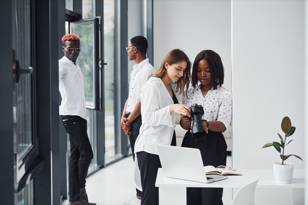 Woman testing camera Group of african american business people working in office together