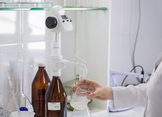 Woman testing samples of dairy products in the laboratory. test laboratory of a milk factory