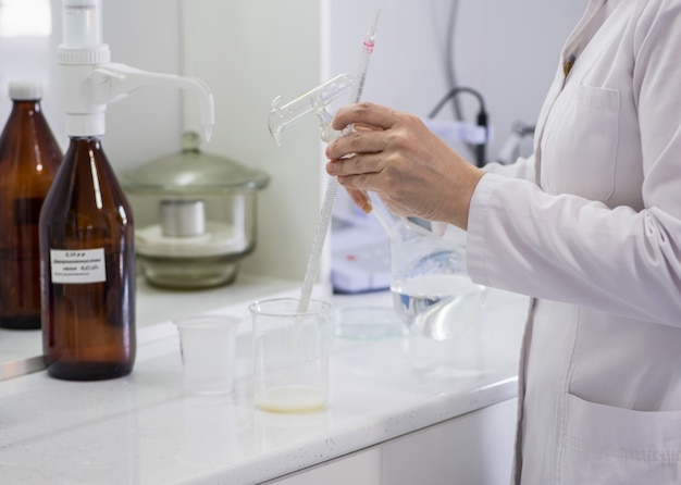 Woman testing samples of dairy products in the laboratory. test laboratory of a milk factory