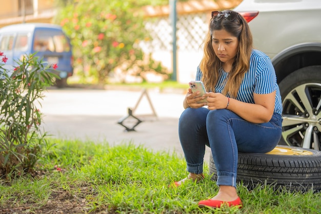 Photo woman texting emergency because she had a crash