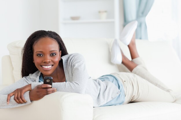 Woman texting on sofa