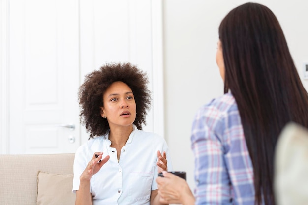 Woman at therapy session Attentive psychologist Attentive psychologist holding pencil in her hands making written notes while listening to her client