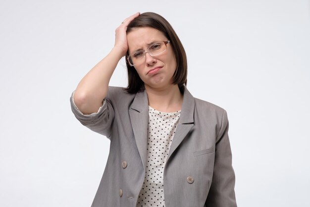 Woman thinking and looking pensive trying to remember important information