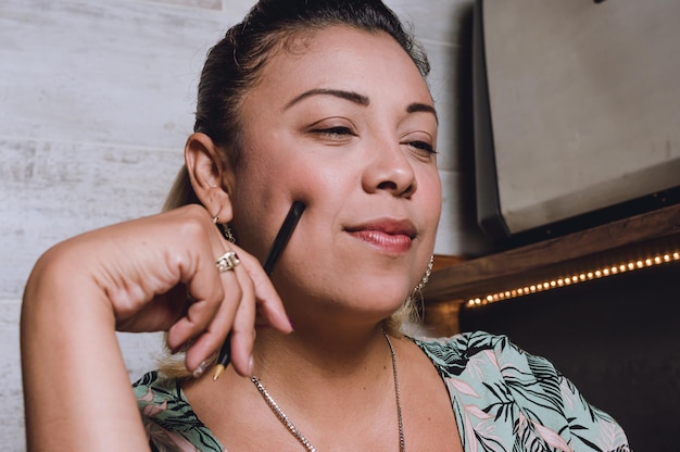 woman thinking with half closed eyes touching her face with a pen in a coffee shop