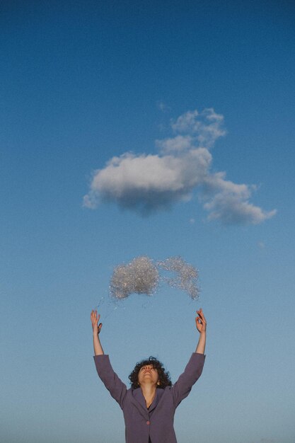 Woman throwing plastic against blue sky