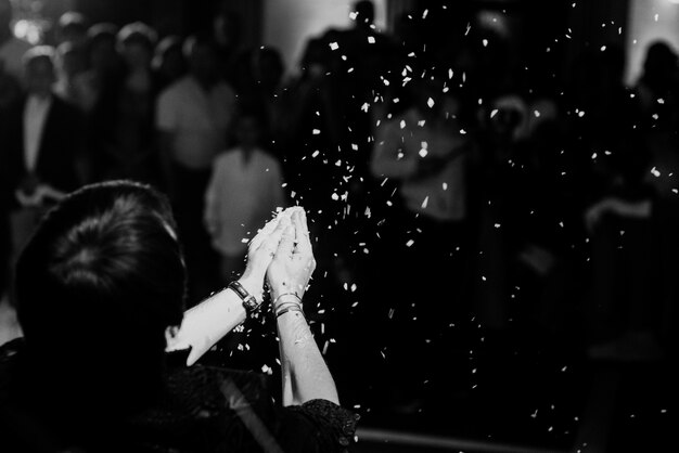 Woman throws rice from her hands