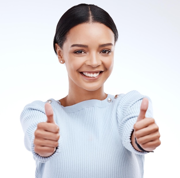 Woman thumbs up and happy in studio portrait with happiness confidence or success by white background Girl model and student with smile hand gesture or agreement for winning goal or achievement