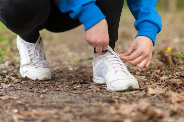 Woman tightening shoelaces