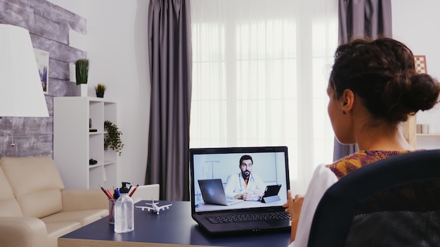 Woman in time of video consultation with her doctor.