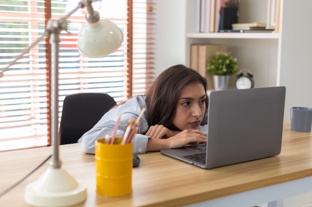 woman tired of work and not inspiration lazy apathetic Girl tired of learning looking at laptop