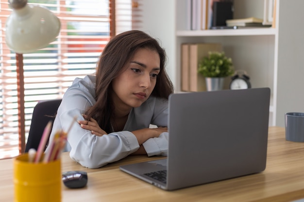 woman tired of work and not inspiration lazy apathetic Girl tired of learning looking at laptop