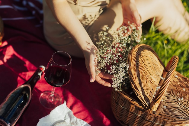 Woman touches the flowers from basket