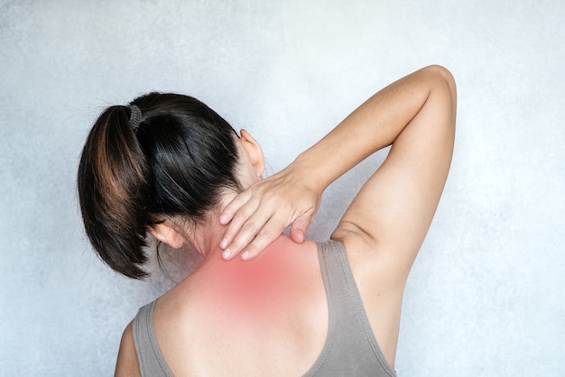 A woman touching her neck with her hand, neck pain, neck pain relief exercises