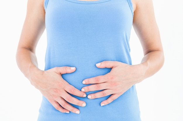 Woman touching her painful stomach 