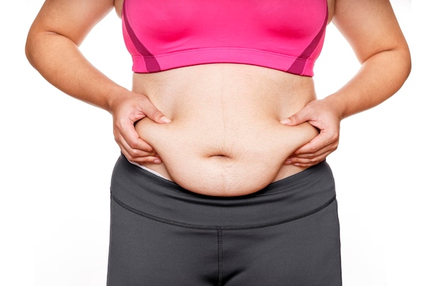 Photo woman touching his fat belly on white background woman hand holding excessive belly fat