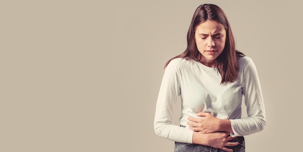 Woman touching his stomach Stomach pain and others stomach disease conceptGirl having a stomachache