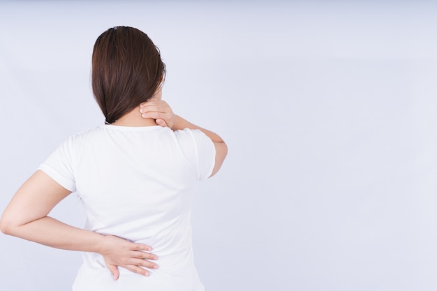 Woman touching neck and lower back pain