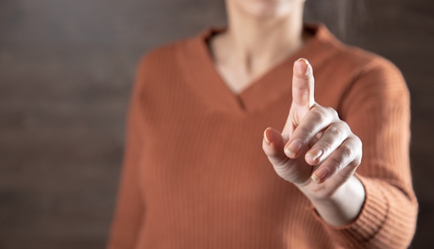 Photo woman touching in screen on the dark background