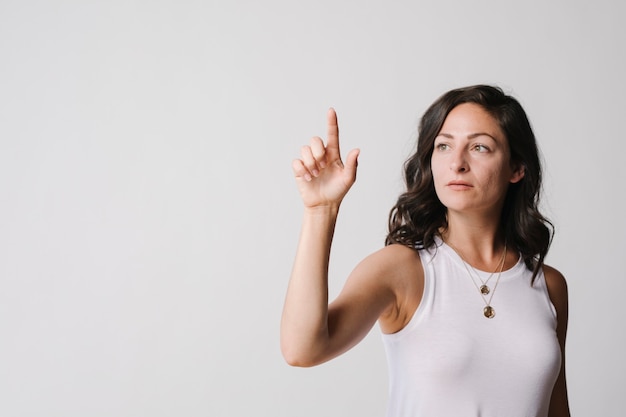 Woman touching a screen with her finger