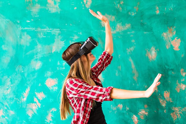 Woman touching something using virtual reality headset glasses.