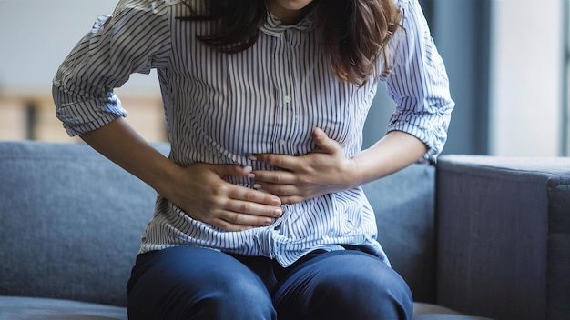 Woman touching stomach painful suffering from stomachache causes of menstruation period gastric