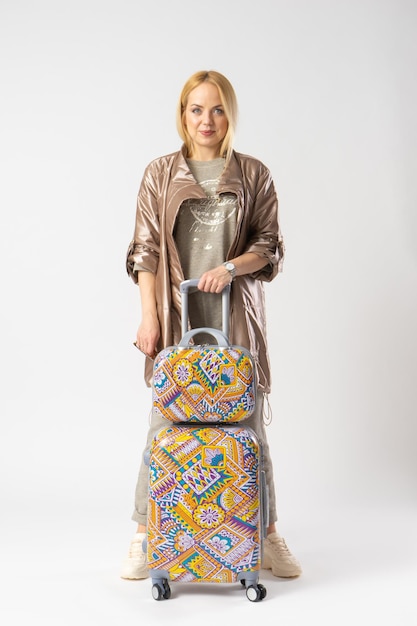 Woman tourist in casual clothes with a large travel suitcase for travel