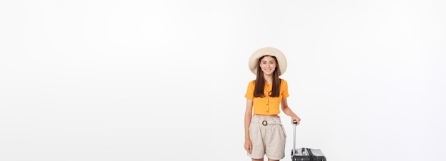 Woman tourist full length happy young woman standing with suitcase with exciting gesturing isolated