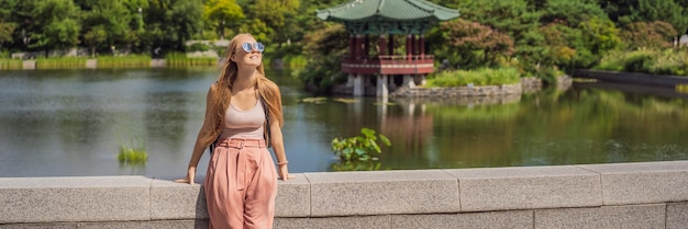 Woman tourist in korea korean palace grounds in seoul south korea travel to korea concept banner