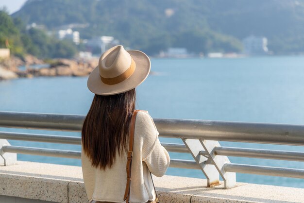 Woman tourist look at the sea and enjoy scenery view