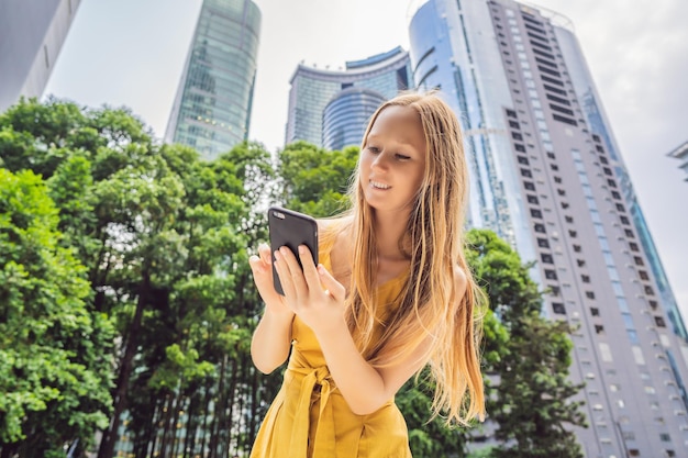 Woman tourist using navigation app on the mobile phone\
navigation map on a smartphone in a big city