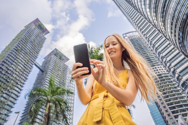 Woman tourist using navigation app on the mobile phone\
navigation map on a smartphone in a big city