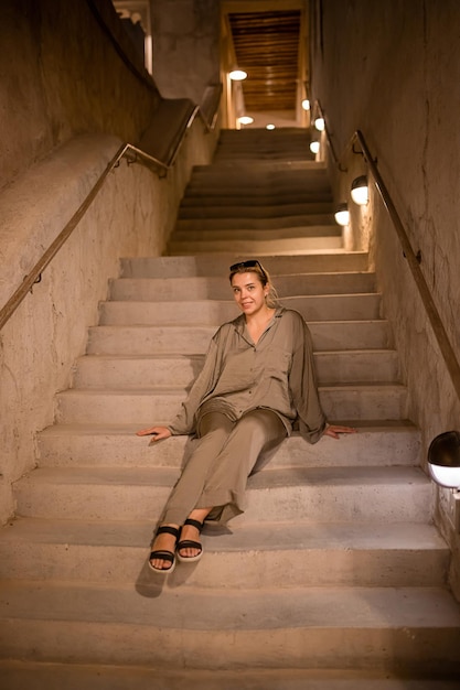 Woman tourist walking in Al Seef Meraas Dubai old historical district with traditional Arabic architecture