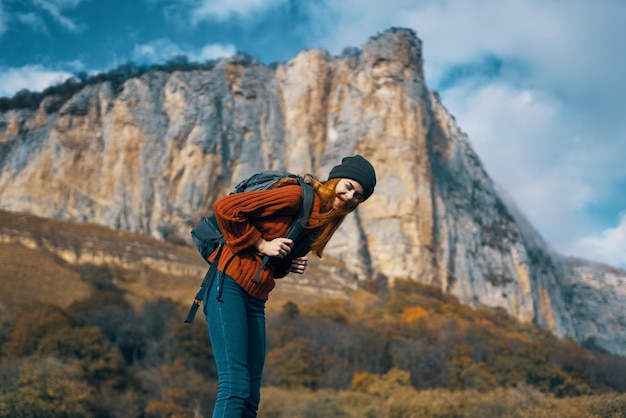 Woman tourist with backpack on nature autumn season travel
