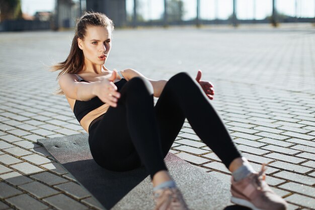 Woman training and doing fitness outdoor