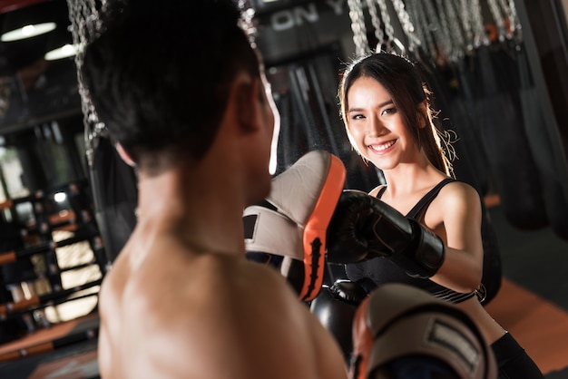 Woman training with boxing gloves at the gym,Couple exercising punching