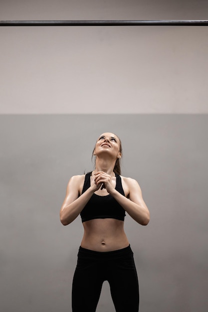 Woman trains on horizontal bars in the gym