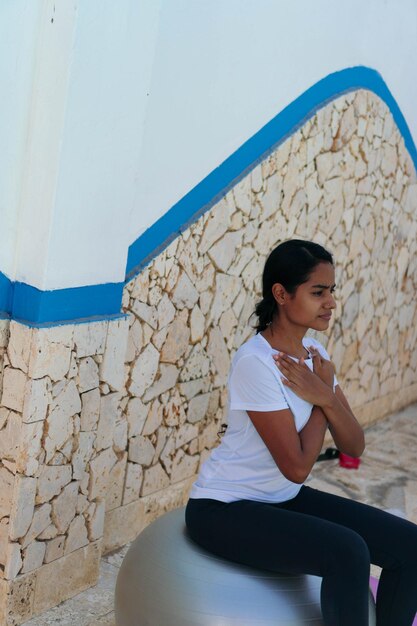 A woman trains in the yard near the pool. Fitness concept at home.