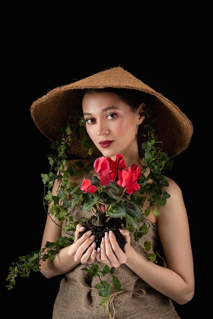 Woman transplanted flower in a ceramic pot Houseplant transplant concept